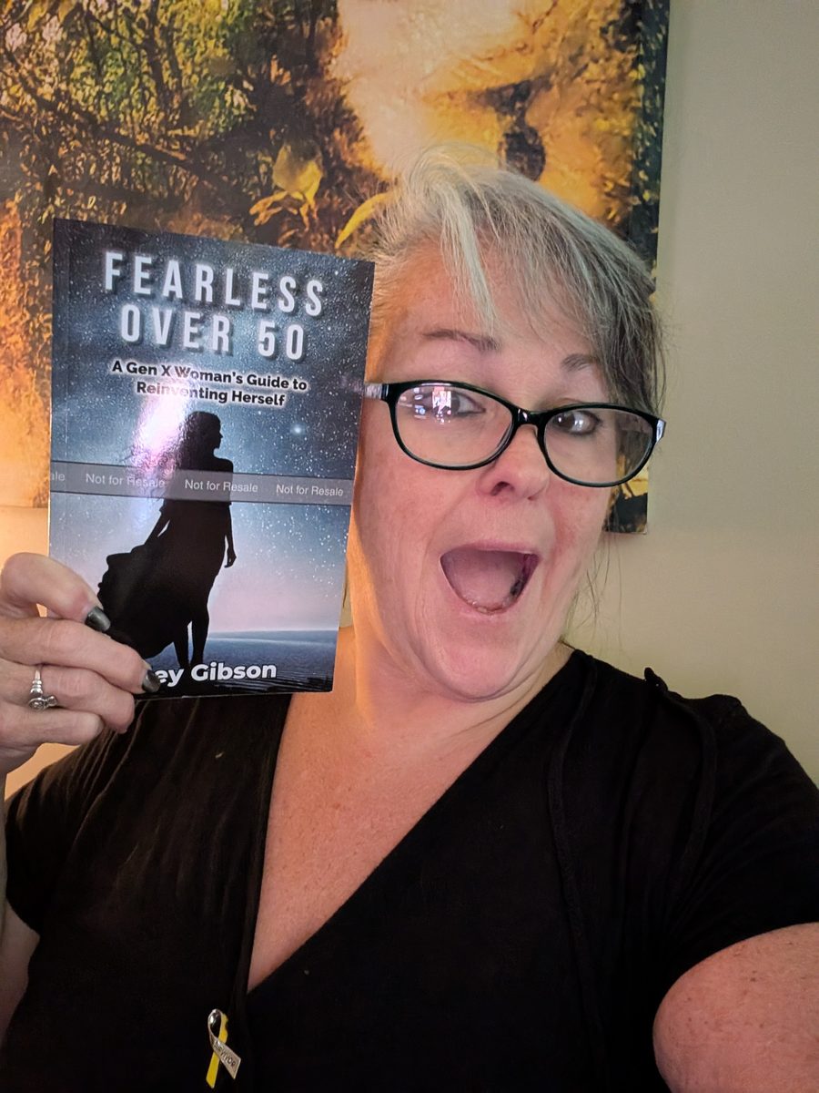 Marley Gibson excitedly holding her book Fearless Over 50